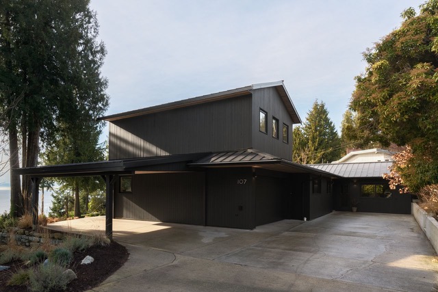 Renovated home with charcoal cedar siding and metal roof
