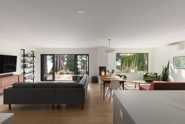 Open living and dining with wood stove and garden view