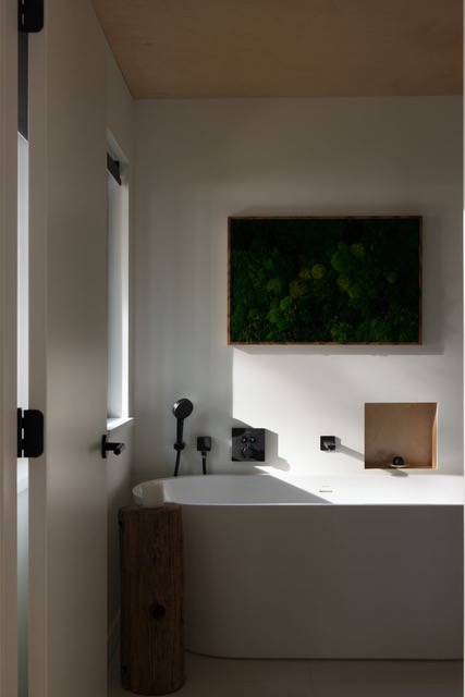 Primary bath with floating tub and moss art